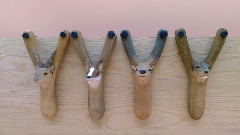 Hand-carved wooden slingshots display