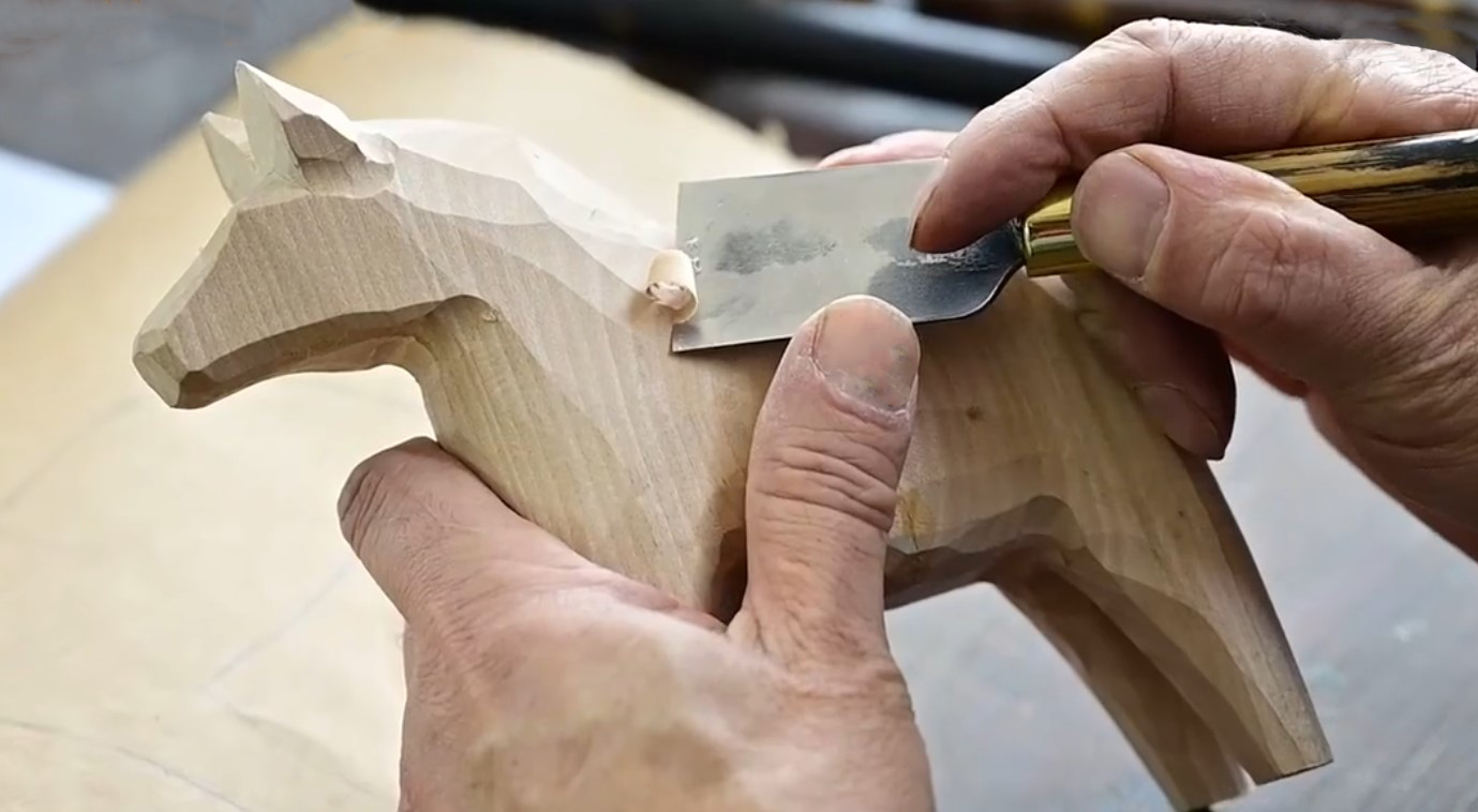 Master craftsman hand-carving wooden crafts showing traditional techniques and attention to detail