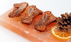 Professionally arranged food display on a pink Himalayan salt block with artistic plating