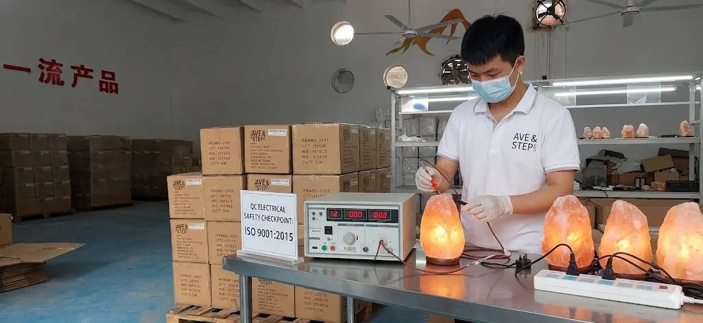 A technician conducting electrical safety tests on a batch of Himalayan salt lamps at our ISO 9001:2015 certified factory to ensure global compliance.