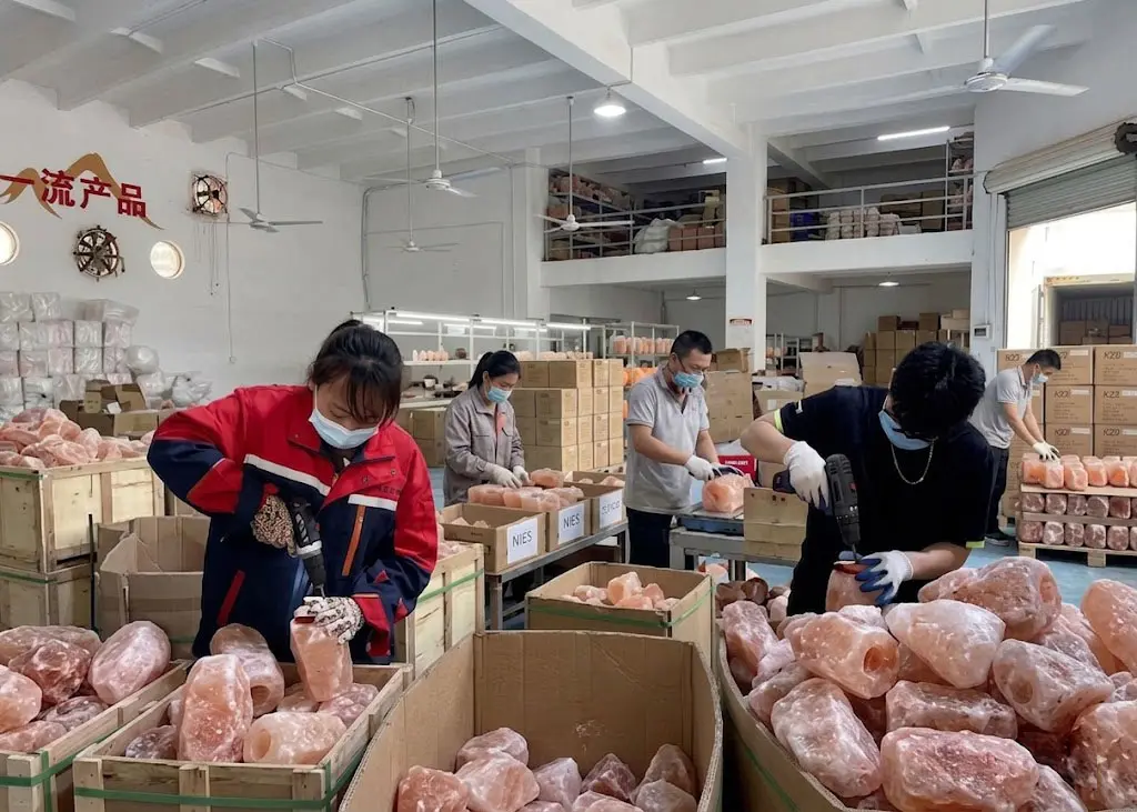 Skilled workers at our Himalayan salt lamp factory performing precision drilling and quality inspection for a bulk wholesale order.