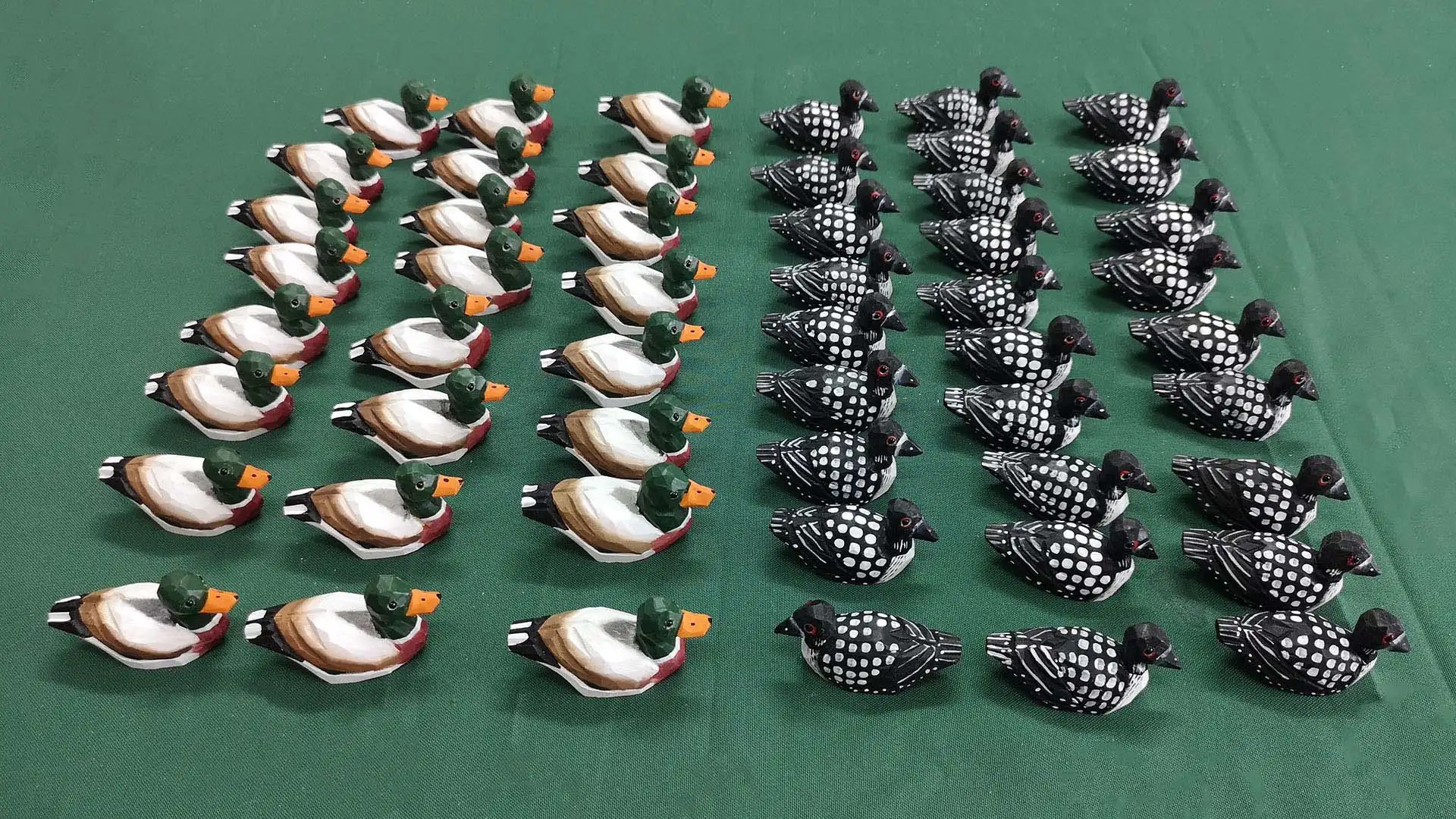 Bulk production of handcrafted wooden duck decoys in a factory showroom for international wholesale export.