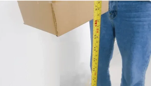 Packaged carton measured during a drop-test quality control check