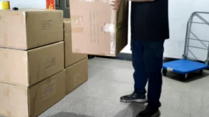 Standard drop test on heavy-duty export cartons to ensure safe international shipping for wholesale orders.