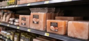 Premium Himalayan pink salt blocks in clear retail packaging displayed on boutique store shelves for health, wellness, and lifestyle consumer markets.