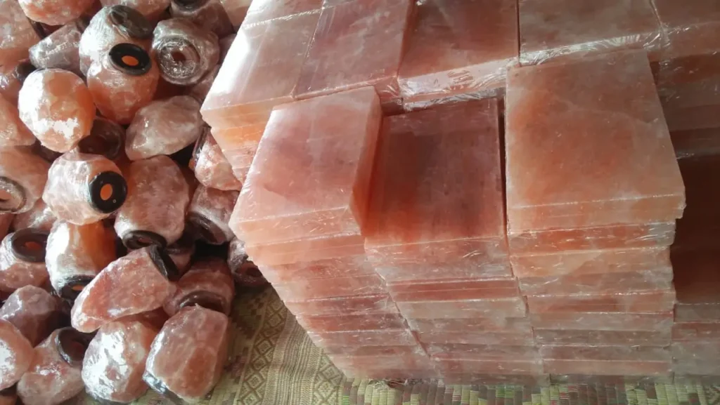 Stacks of shrink-wrapped wholesale Himalayan salt bricks ready for bulk B2B export.