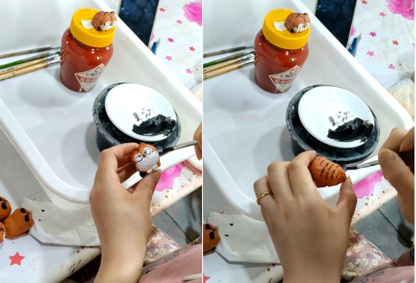 Artisan hand-painting a wooden bird carving sample at the Jilin Ever Creation factory