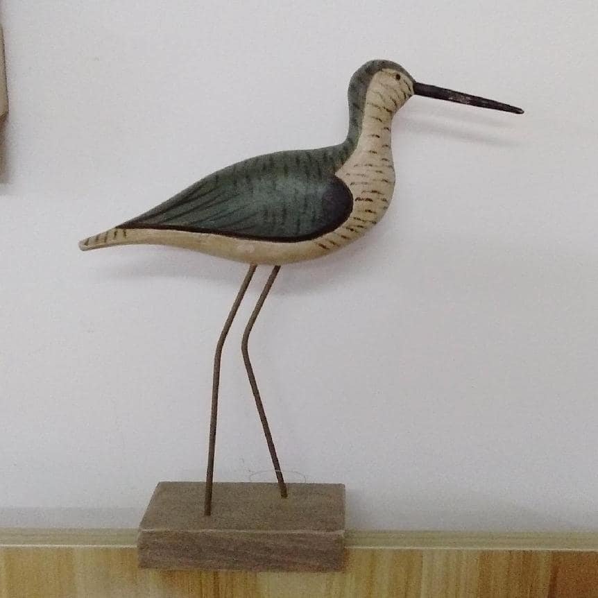 Vintage stick bird avocet decoy with long beak on wooden base — white background, hand-carved pine with muted earth-tone paint