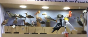 Our comprehensive coastal collection: Hand-carved wooden pelicans, seagulls, and shorebirds displayed at our factory exhibition.
