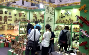 Face-to-face sourcing: International buyers exploring hand-carved wooden decor and Himalayan salt products at our trade show booth.