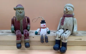Hand-carved wooden Santa and snowman Christmas ornaments and figures as sustainable christmas decor alternatives to plastic