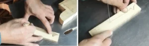 Craftsman tracing design and cutting wooden blanks on a bandsaw in the workshop